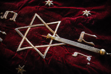 Torah scrolls in a purple case with Hebrew symbols. Torah is used in synagogues especially during the Juwish holidays.