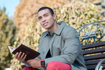 Obraz premium Dreamy male person sitting on the bench