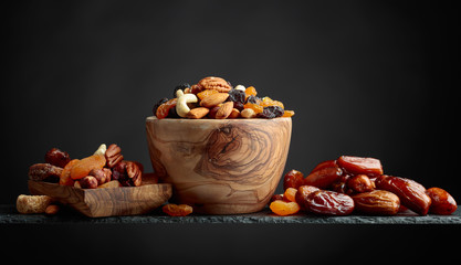 Fototapeta na wymiar Various dried fruits and nuts in wooden dish.