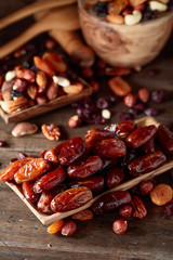 Various dried fruits and nuts in wooden dish.
