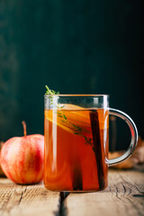 Apple tea with cinnamon, wooden background, retro rustic style, autumn mood
