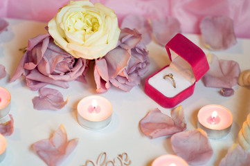 Valentine's Day Surprise.  Romantic evening with the beloved with rose petals on the bed and a ring for a marriage proposal on February 14