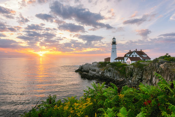 Fototapeta na wymiar Sunrise over the ocean from Portland Head Light in Cape Elizabeth, Maine 