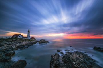 Cloud movement from a long exposure at dawn over Portland Head Lighthouse in Maine 
