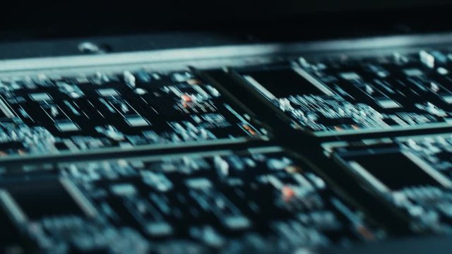 Factory Machinery at Work: Printed Circuit Board Being Assembled with Automated Robotic Arm, Pick and Place Technology Mounts Microchips to the Motherboard. Macro Close-up Footage.