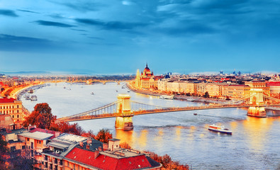 Fototapeta na wymiar The creative processed landscape photography of Budapest city, view on Chain Bridge and Parliament Building over Danube river delta - the Golden Town beneath the Blue Sky - concept of Dream city.