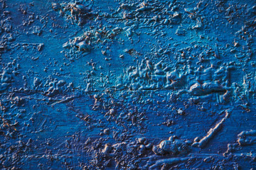 Bright turquoise blue painted textured surface made of construction foam on wood