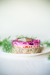 layered salad of boiled vegetables with beets and herring