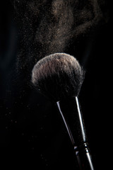makeup brush on black background