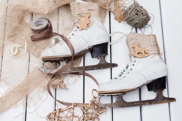 Top view of stages of making Christmas decoration of old vintage ice skates with ribbons