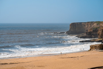 Sea shore with waves on sunny day