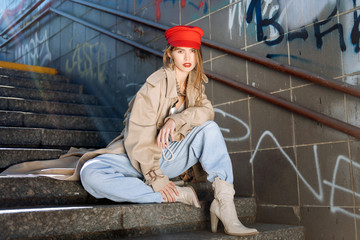 Famous model posing for the magazine cover in beige high-heeled boots