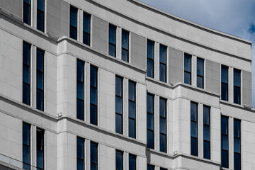 Fototapeta premium Part of facade of european building with blue windows close up. European architecture example