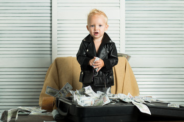 Startup business costs. Boy child with money case. Little entrepreneur work in office. Little boy...