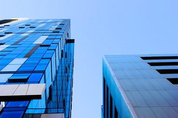 Glass skyscrapers against blue sky