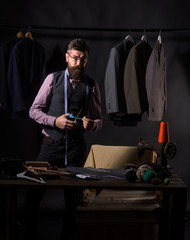 Passionate about work. sewing mechanization. business dress code. Handmade. retro and modern tailoring workshop. suit store and fashion showroom. Bearded man tailor sewing jacket. Confident tailor