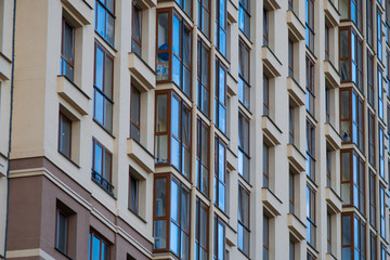 Fototapeta premium Facade of big modern building with apartments. Mortgage, accomodation, real estate construction concept