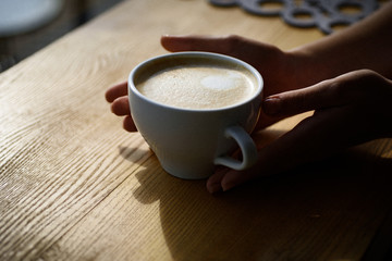 relax in cafe or coffee shop and drinking. fresh morning coffee with milk and cream froth. perfect morning with best coffee. barista propose americano or espresso coffee cup. Tastes delicious