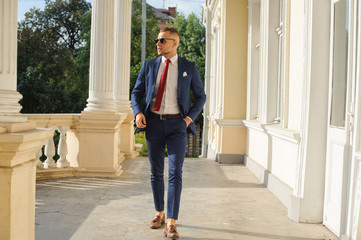 Handsome male model posing wearing a blue suit.