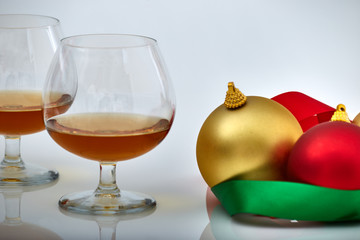 closeup of liquor glass with Christmas ornaments