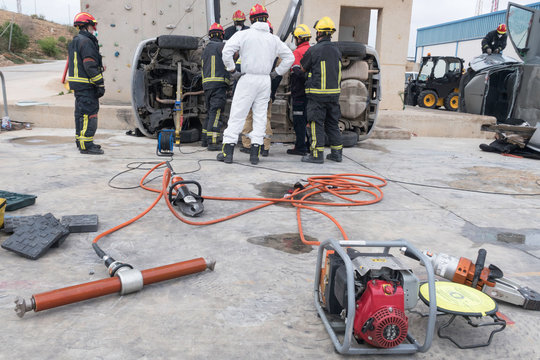 Firemen practicing techniques of rescue of victims in traffic accidents with tools