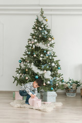 New Year concept, a boy near a Christmas tree