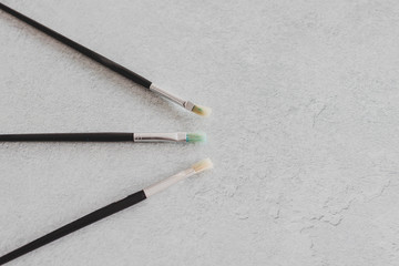 Fototapeta premium paintbrushes on concrete surface with copyspace for your text