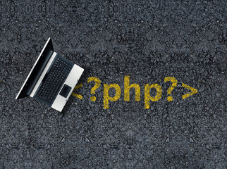 php programming language. Laptop on php tag drawn with paint on road asphalt