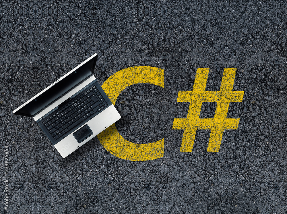 Poster C sharp programming language. Laptop on c# drawn with paint on road asphalt