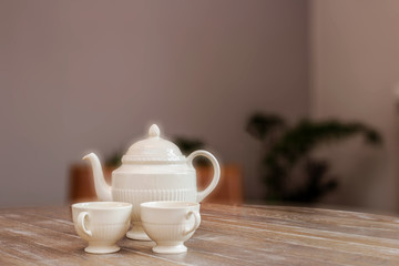 tea pot and cups on wooden table, still life in a home vintage design cute and cozy, space for text