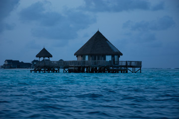 amazing bungalows in the middle of the sea in the Maldives at sunrise