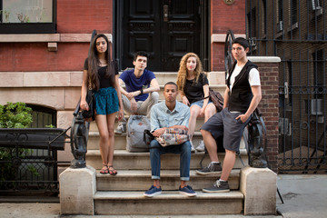 Fototapeta premium Portrait of friends on steps against building