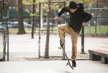 Man practicing skateboard stunt at skateboard park © Cavan for Adobe