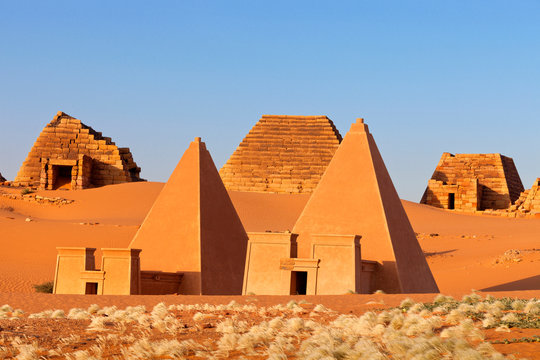 Pyramids in desert against sky