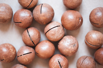 Macadamia nuts closeup on table. Selective focus. Healthy nutrition.