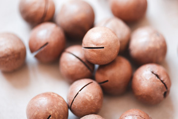 Macadamia nuts closeup on table. Selective focus. Healthy nutrition.