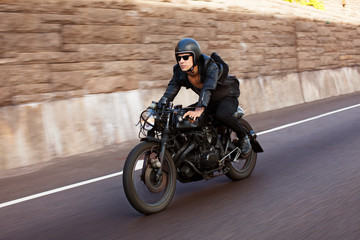 Man riding motorcycle on road © Cavan for Adobe