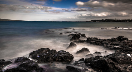 smooth wave on rocky beach