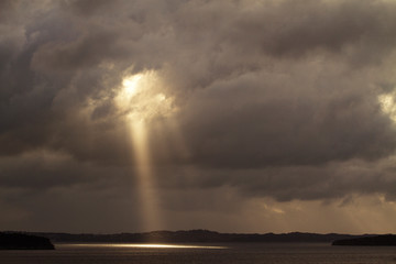 Sunlight emitting from cloudy sky on sea © Cavan for Adobe