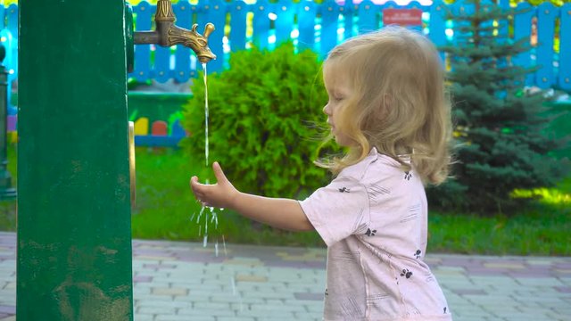 Girl washing hand in park