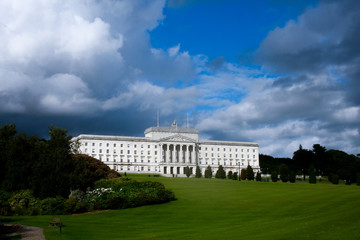 Obraz premium Dark storm clouds gathering over Northern Ireland Executive - Parliament Buildings, Stormont, Belfast