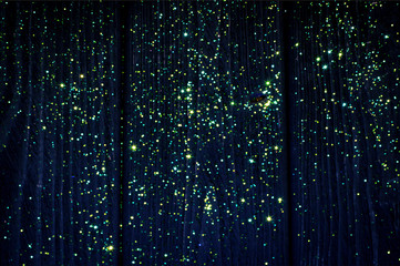 On the deep blue wood background glow yellow and green stars