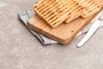 Crispy toasts for breakfast with knife and napkin