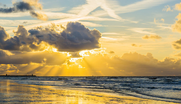 Beach at sundown time giving dawn light effect in the sky and beautiful waves in the sea