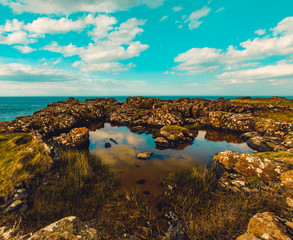 Fototapeta na wymiar Beautiful sea landscape on Causeway Road, Co Antrim, Northern Ireland.Photo taken on a small road to Dunseverick Harbour. From here you can see Dunseverick Falls.