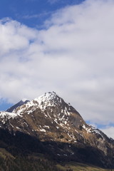 Fototapeta na wymiar Snow on Hintereggkogel and Ochsenbug Mountain peaks in ski resort Matrei in Osttirol, Austria, sunny day