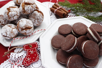 Two types of cookies, chocolate with cream and spicy ginger with cracks.