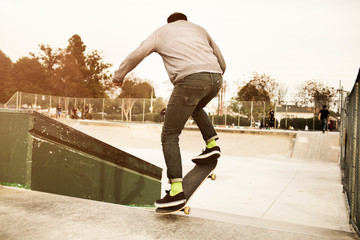 Rear view of man skateboarding in park © Cavan for Adobe