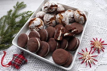 Two types of cookies, chocolate with cream and spicy ginger with cracks.