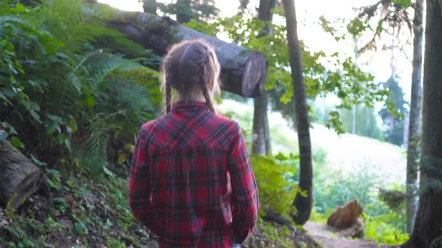 Beautiful happy little girl in mountains in the background of fog